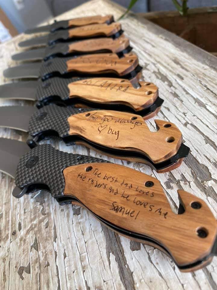 Set of seven wooden handled, black blade, engraved knives