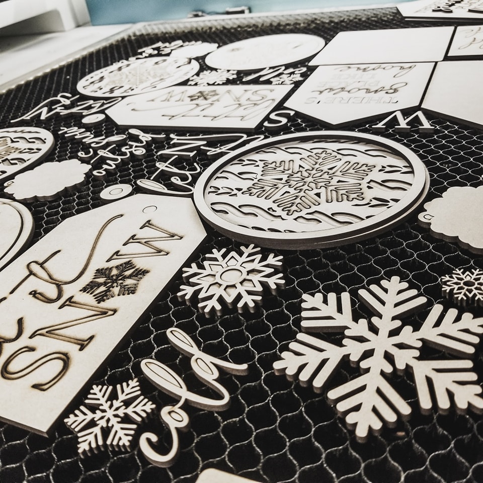 Wooden cut outs of snow and winter themed artworks