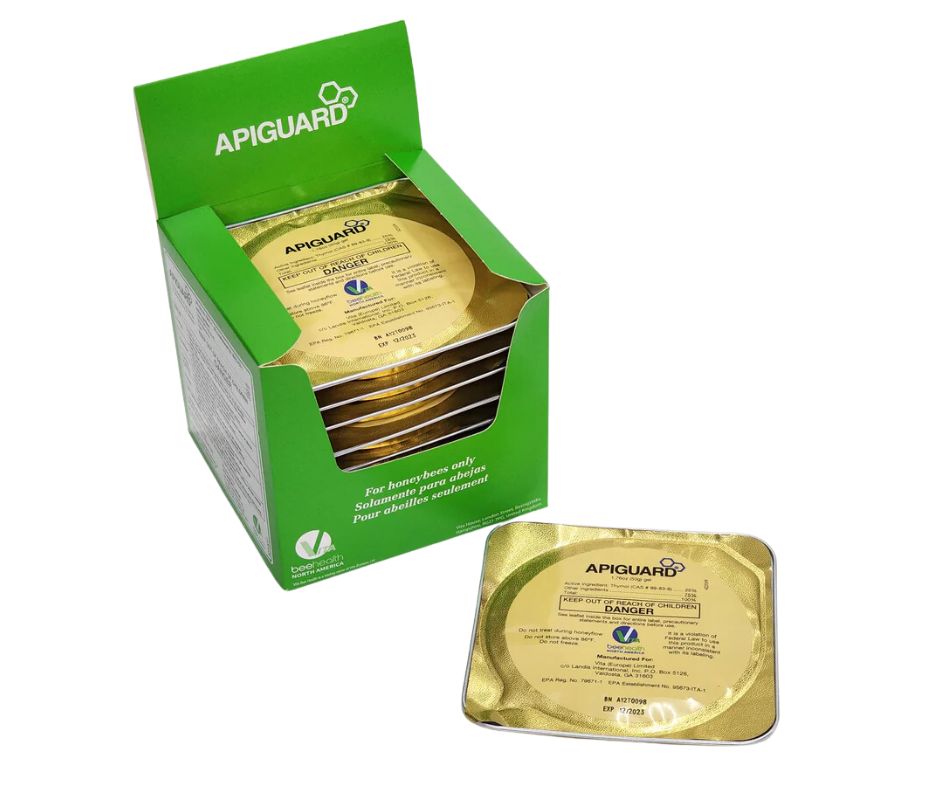 A green box labelled "Apiguard" filled with gold foil individually wrapped trays of apiguard. 